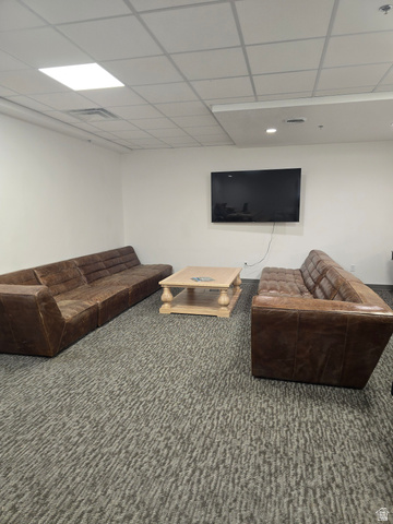 2085 North Main Street, Unit 412 Sunset, UT 84015 - Photo 13 of 14 Spacious room featuring textured gray carpeting, white walls, and a drop ceiling with integrated lighting