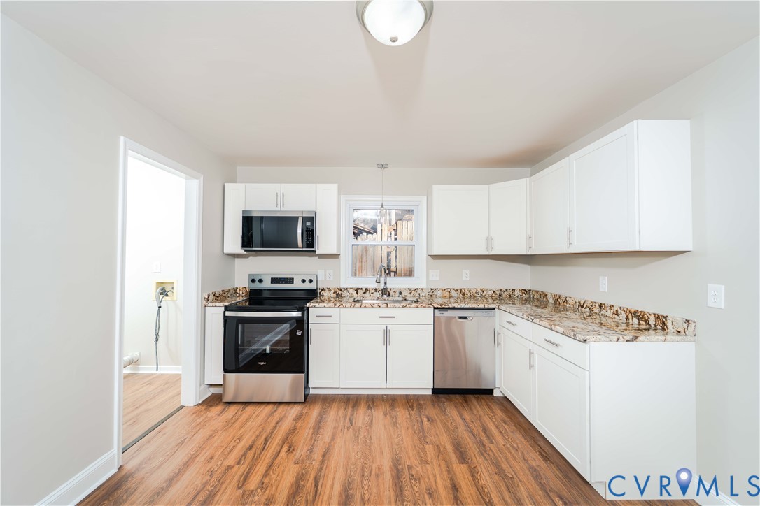 3025 Maplevale Road Chester, VA 23831 - Photo 5 of 14 Kitchen featuring wood-finish flooring, white cabi