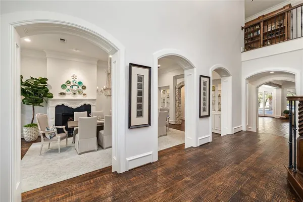 a view of a dining room with furniture a rug and a chandelier