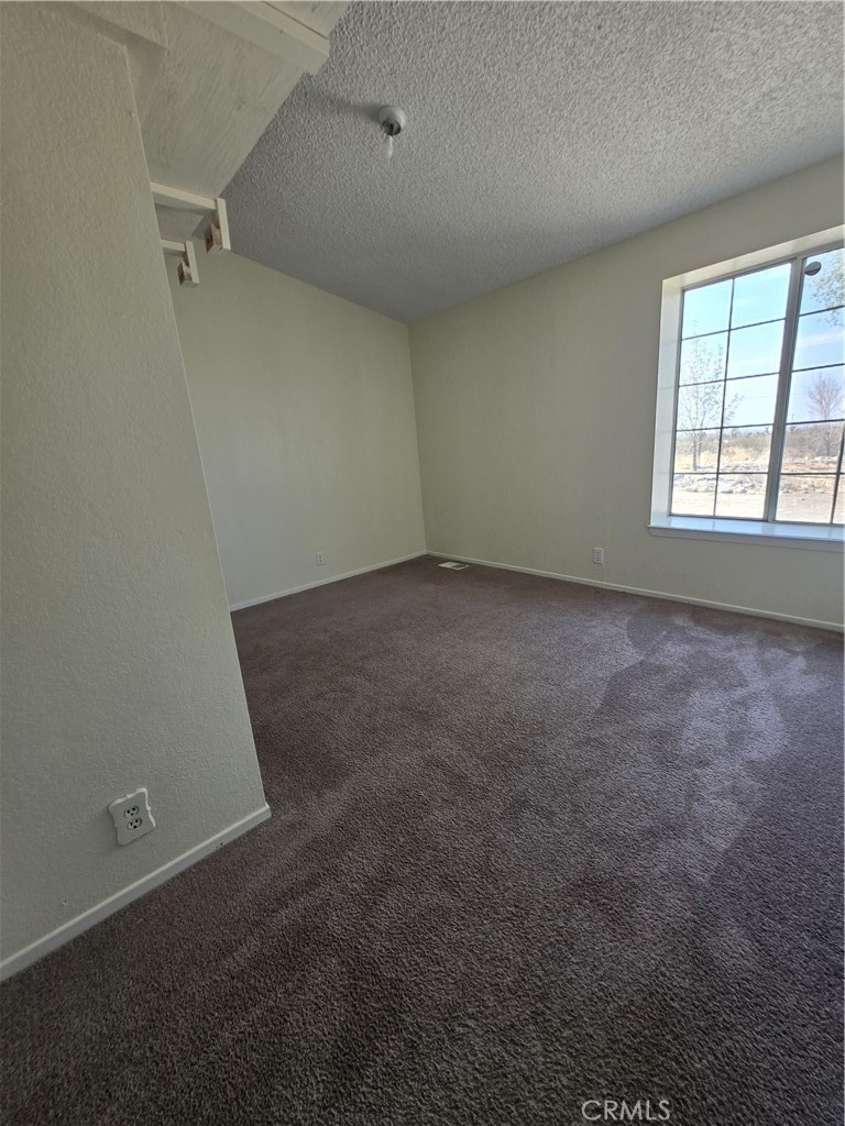 12285 Golden View Road Pinon Hills, CA 92372 - Photo 15 of 21 an empty room with a empty space and windows