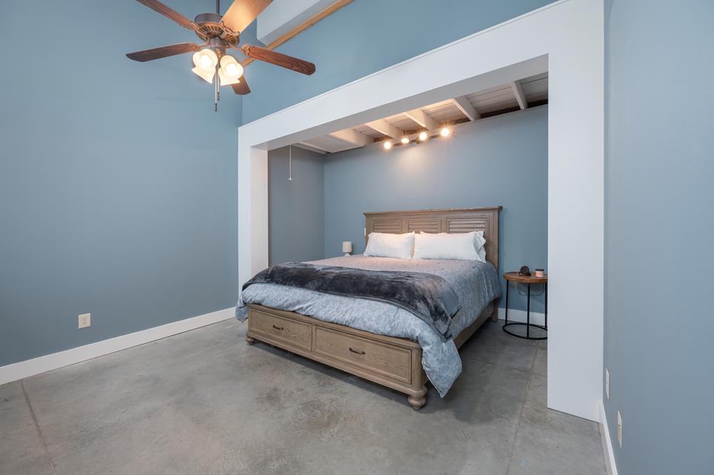 1201 Front Avenue, Unit 222 Columbus, GA 31901 - Photo 22 of 29 a bedroom with a bed and a ceiling fan