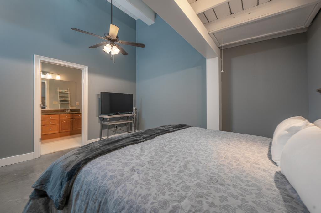 1201 Front Avenue, Unit 222 Columbus, GA 31901 - Photo 24 of 29 a bedroom with a bed and a flat screen tv