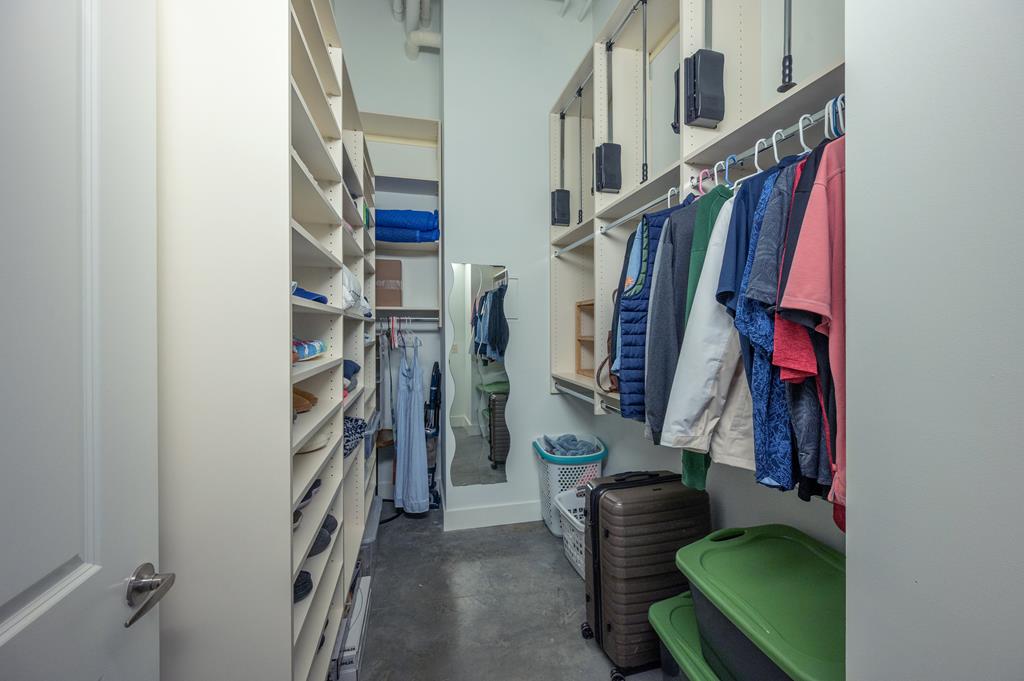 1201 Front Avenue, Unit 222 Columbus, GA 31901 - Photo 25 of 29 a view of walk in closet with clothes and shoes