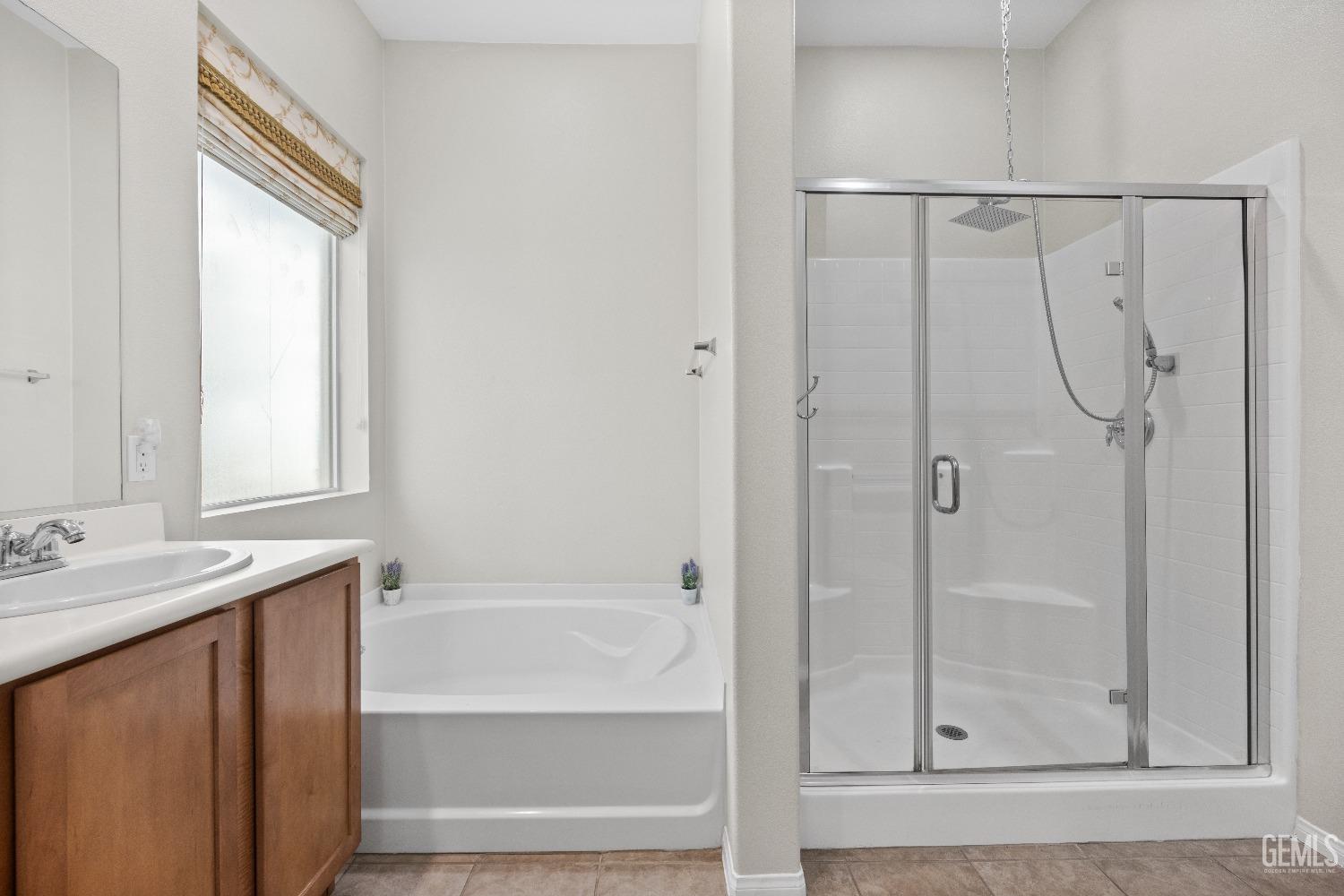 Undisclosed Address Bakersfield, CA 93306 - Photo 15 of 24 a bathroom with a shower curtain and a sink