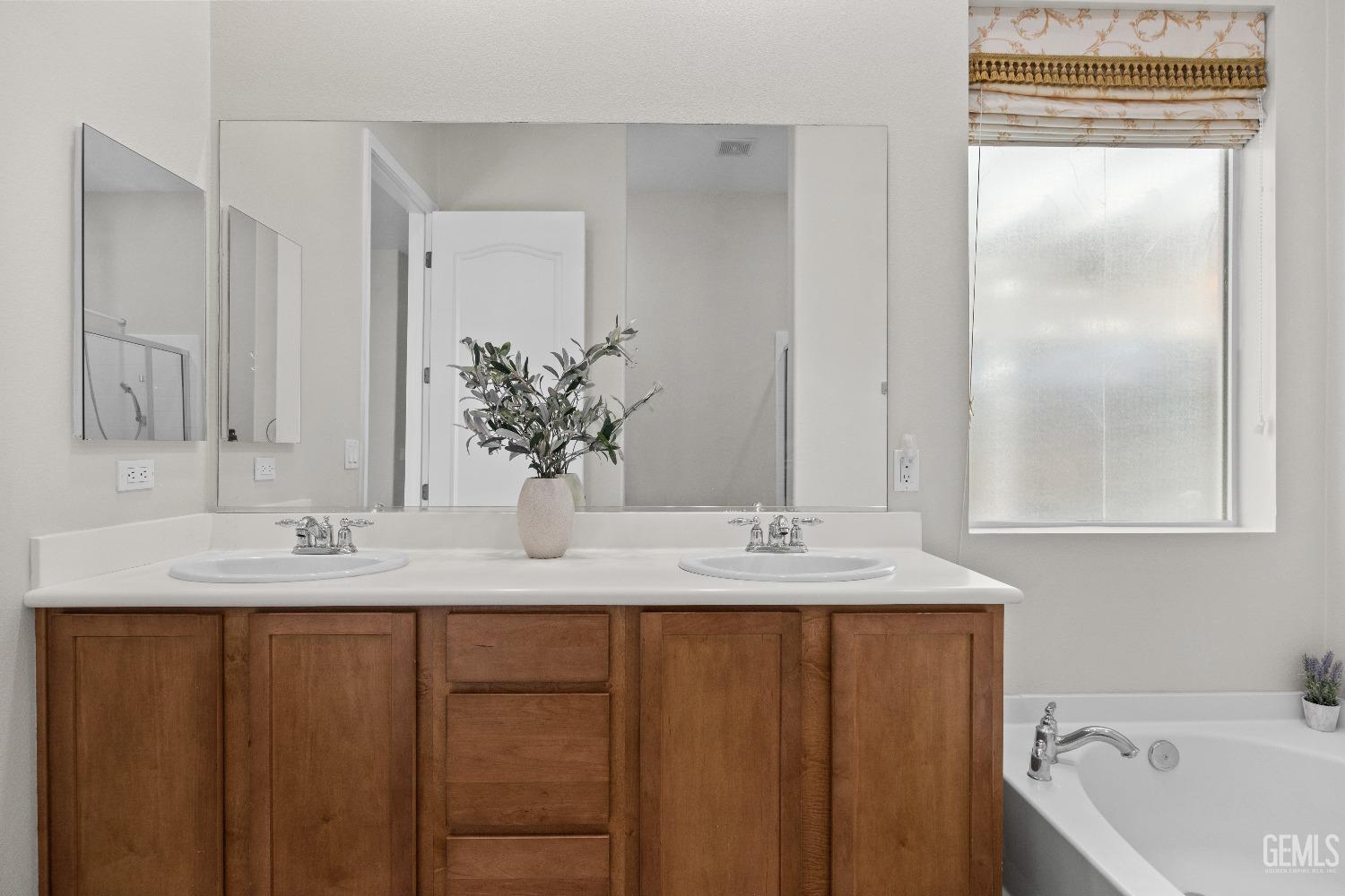 Undisclosed Address Bakersfield, CA 93306 - Photo 16 of 24 a bathroom with a granite countertop sink and a mirror