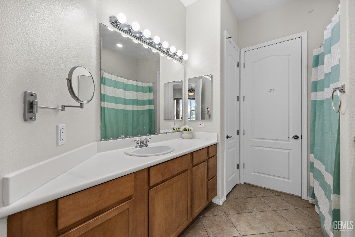 Undisclosed Address Bakersfield, CA 93306 - Photo 18 of 24 a spacious bathroom with a double vanity sink mirror and shower