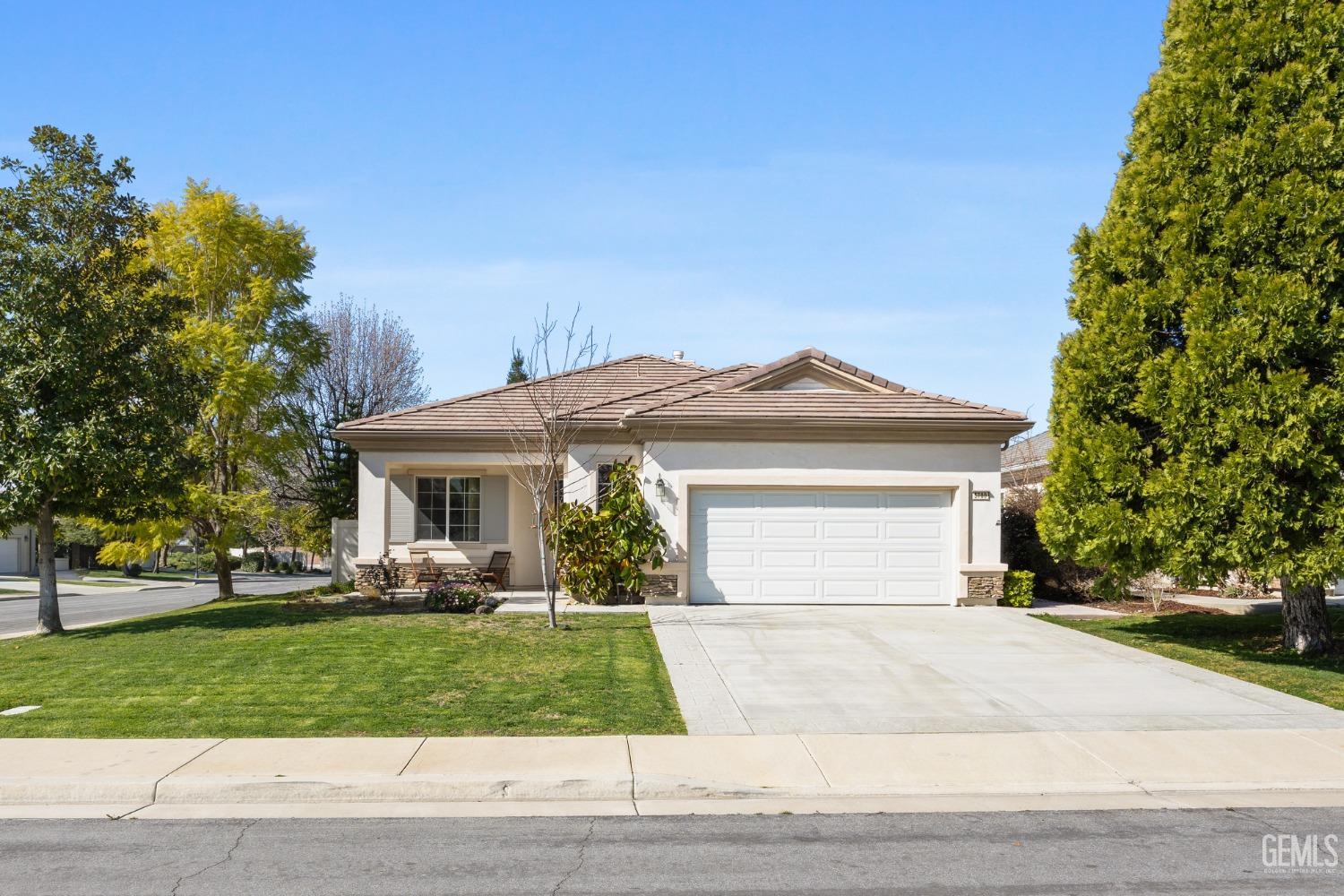 Undisclosed Address Bakersfield, CA 93306 - Photo 2 of 24 a front view of a house with a yard and trees