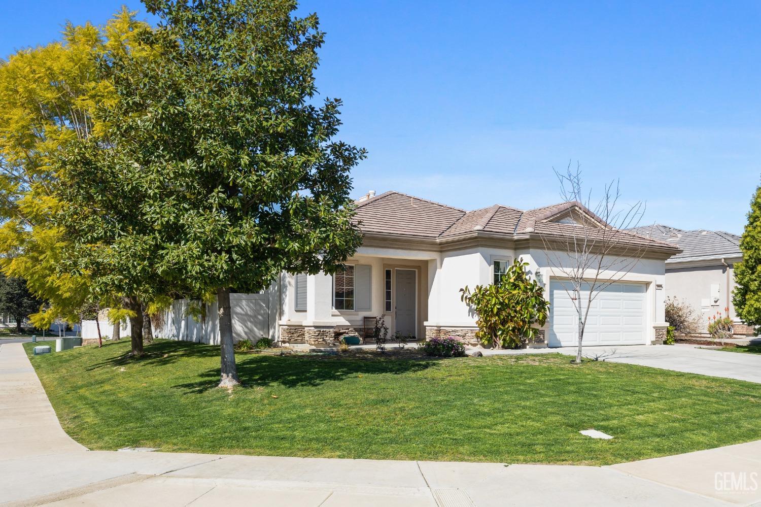 Undisclosed Address Bakersfield, CA 93306 - Photo 3 of 24 a front view of a house with a garden