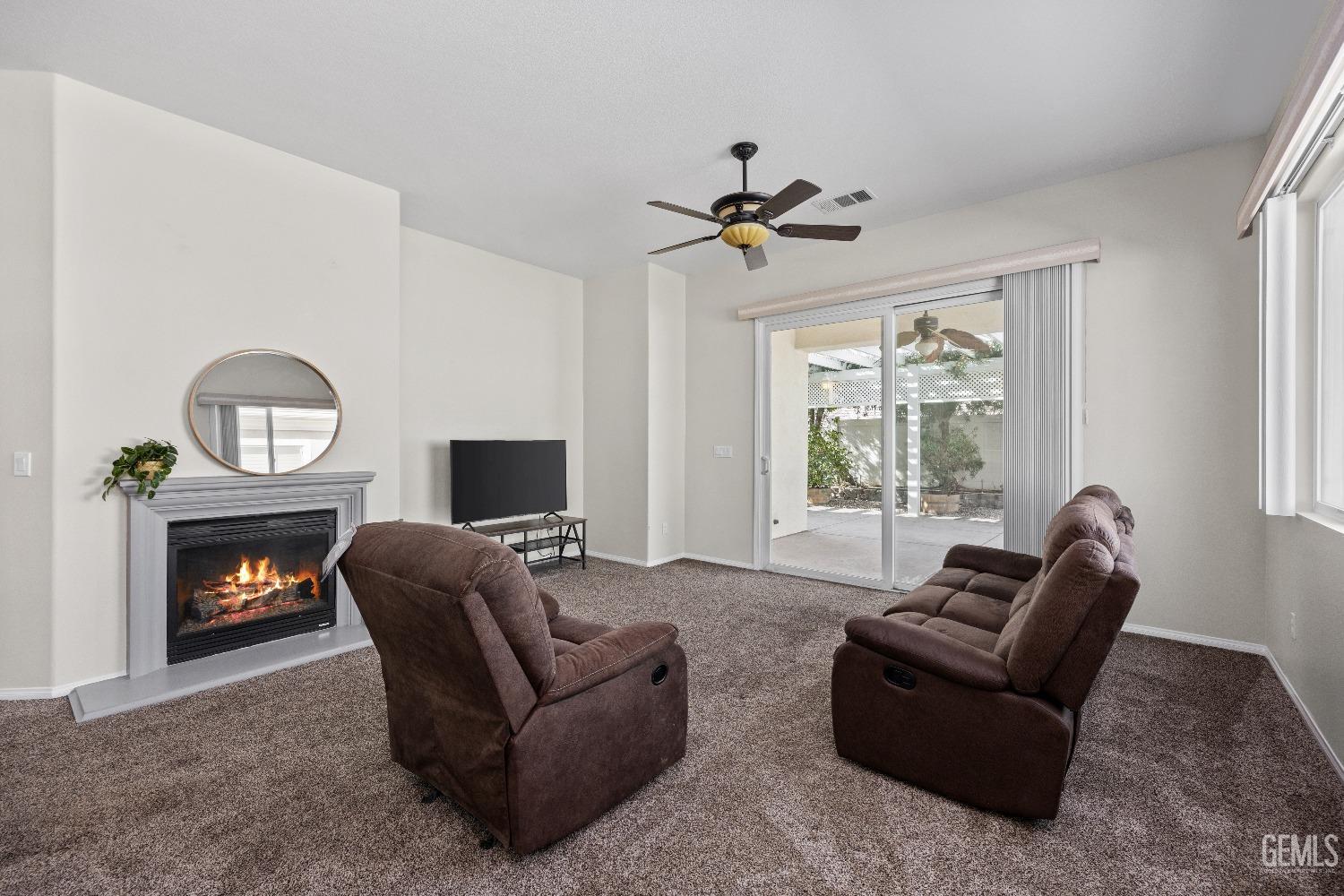 Undisclosed Address Bakersfield, CA 93306 - Photo 5 of 24 a living room with furniture a window and a fireplace