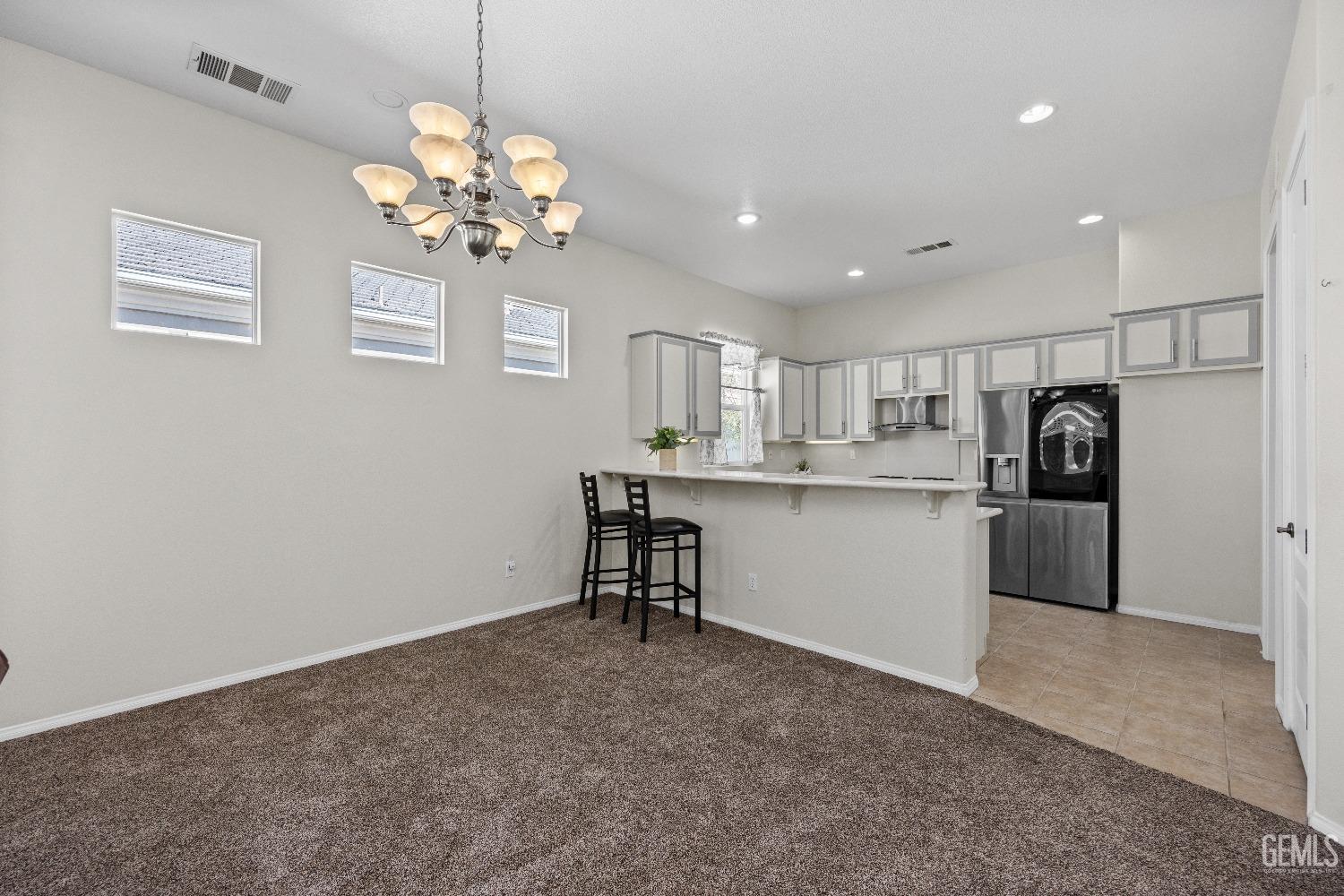 Undisclosed Address Bakersfield, CA 93306 - Photo 9 of 24 a kitchen with a refrigerator and chandelier