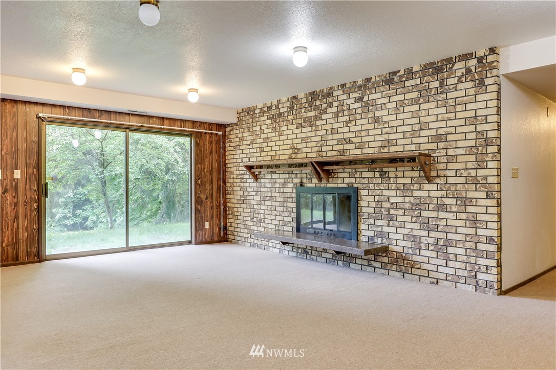 720 South 55th Street Renton, WA 98055 - Photo 14 of 22 a view of empty room with floor to ceiling window and ceiling fan