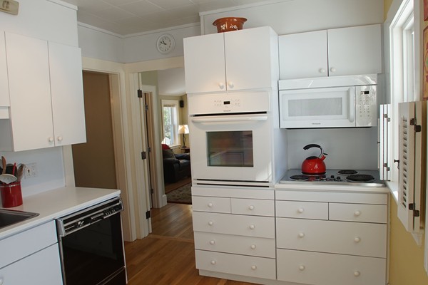 37 Kendall Road Lexington, MA 02421 - Photo 15 of 29 a kitchen with white cabinets and appliances
