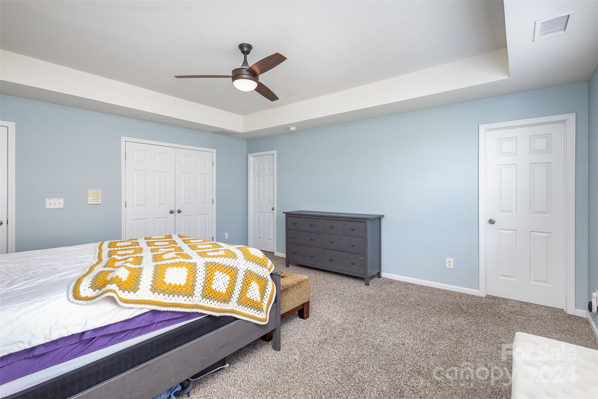 311 Wave Crest Drive Fort Mill, SC 29708 - Photo 15 of 45 a bedroom with a bed and a chandelier