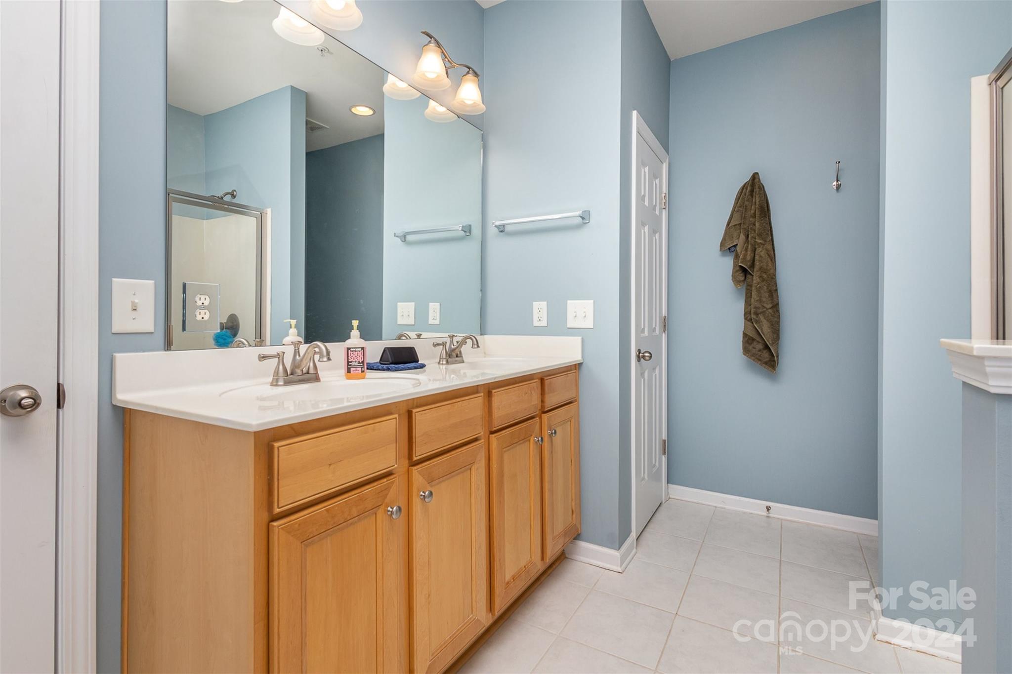 311 Wave Crest Drive Fort Mill, SC 29708 - Photo 17 of 45 a bathroom with a double vanity sink and a mirror