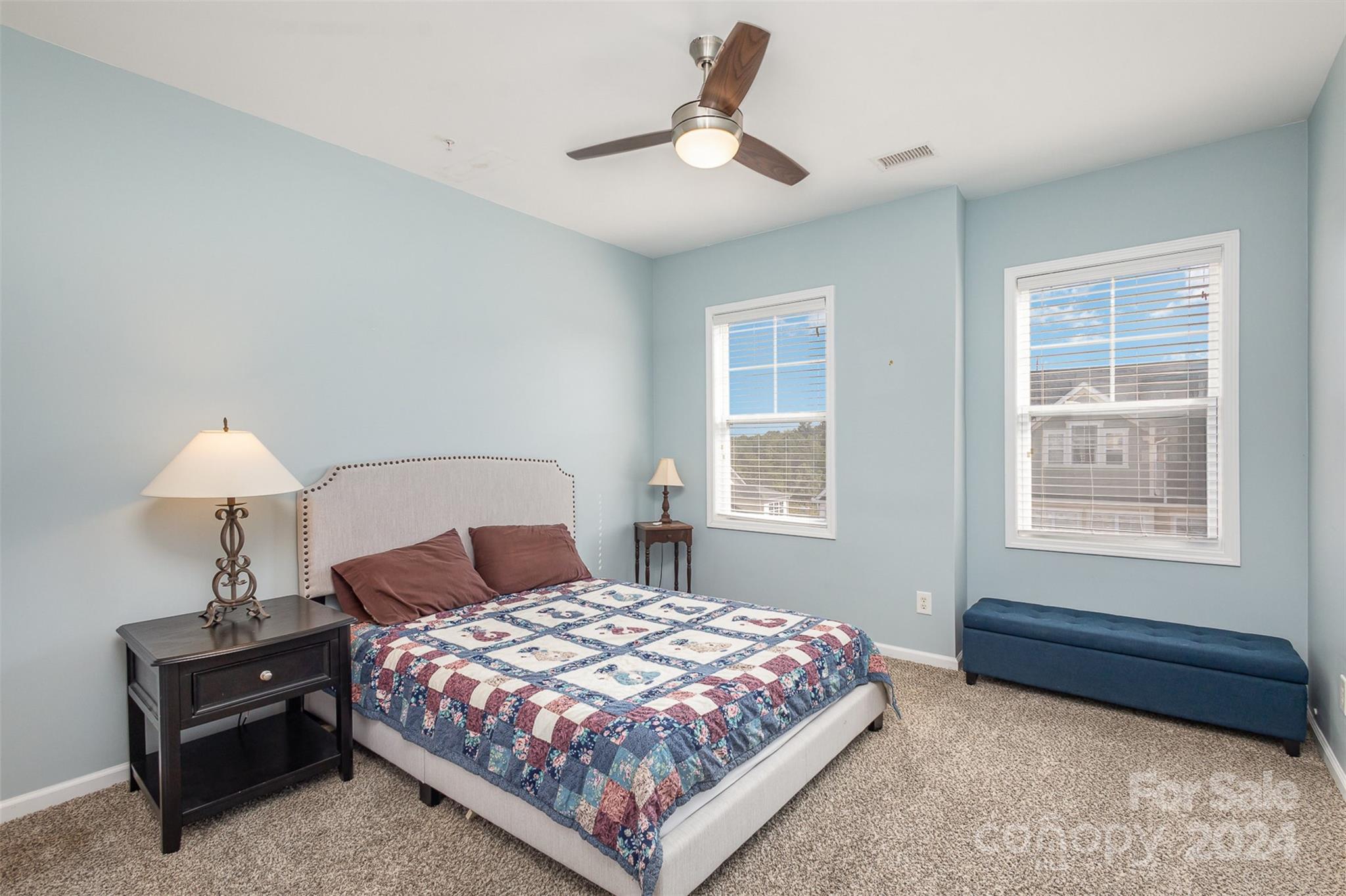 311 Wave Crest Drive Fort Mill, SC 29708 - Photo 18 of 45 a bedroom with a bed lamp and a window