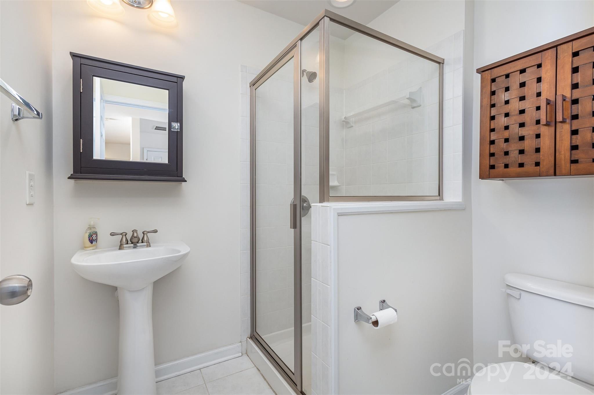 311 Wave Crest Drive Fort Mill, SC 29708 - Photo 28 of 45 a bathroom with a sink mirror toilet and shower