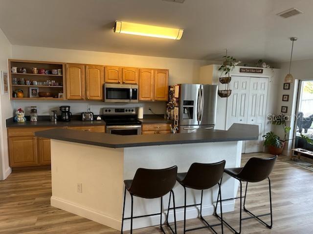 207 Tree Branch Lane Edgewater, FL 32141 - Photo 11 of 22 a kitchen with stainless steel appliances granite countertop a refrigerator and a stove top oven