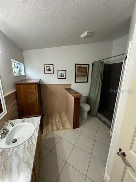 207 Tree Branch Lane Edgewater, FL 32141 - Photo 17 of 22 a bathroom with a sink a mirror and a toilet