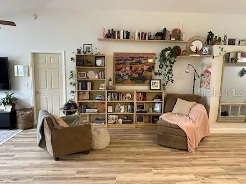 a living room with furniture and a wooden floor