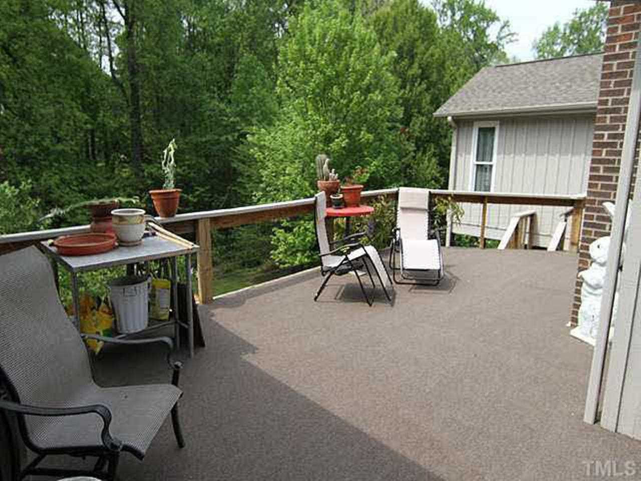 6909 Slade Hill Road Raleigh, NC 27615 - Photo 18 of 25 Wonderful large deck and covered porch with screening that overlooks backyard and small pond. Deck has been treated every 5 years and then re-carpeted with outdoor carpet for shoeless comfort. Patio Deck