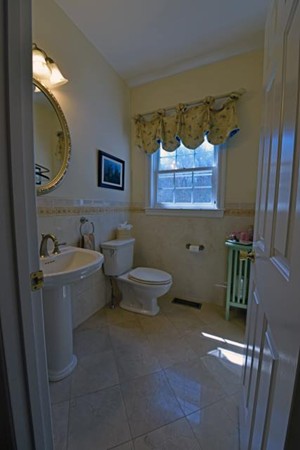 102 Argilla Road Andover, MA 01810 - Photo 11 of 30 a bathroom with a toilet sink and mirror