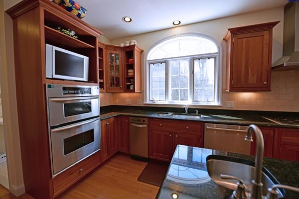 102 Argilla Road Andover, MA 01810 - Photo 13 of 30 a kitchen with stainless steel appliances granite countertop a stove a sink and a microwave