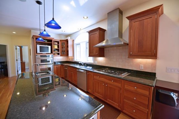 102 Argilla Road Andover, MA 01810 - Photo 15 of 30 a kitchen with stainless steel appliances granite countertop a sink a stove and a refrigerator