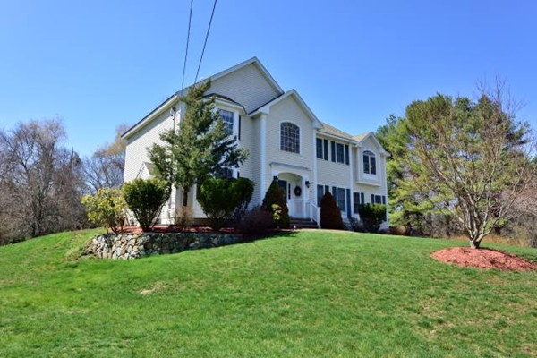 102 Argilla Road Andover, MA 01810 - Photo 3 of 30 a front view of a house with a yard and trees