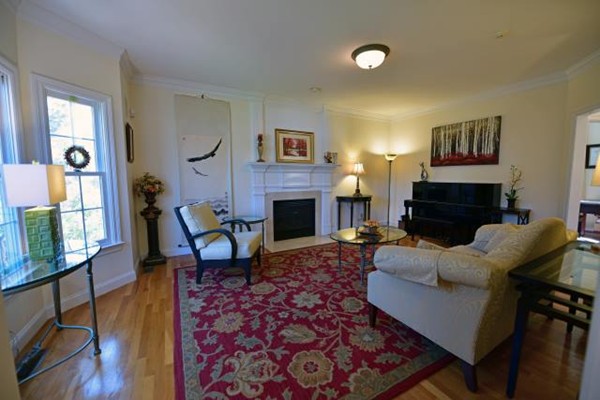 102 Argilla Road Andover, MA 01810 - Photo 8 of 30 a living room with furniture a flat screen tv and a fireplace