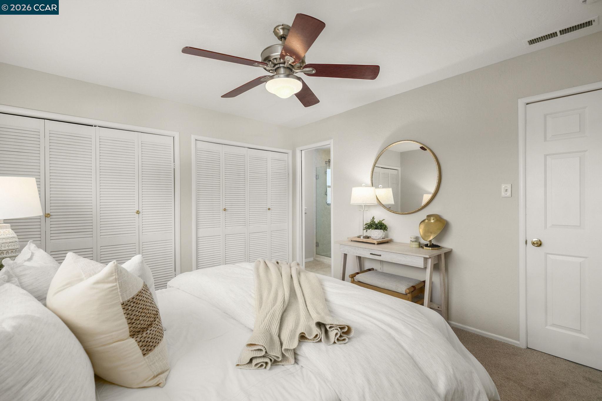 4311 Cowell Road Concord, CA 94521 - Photo 21 of 29 a bedroom with a bed and a chandelier