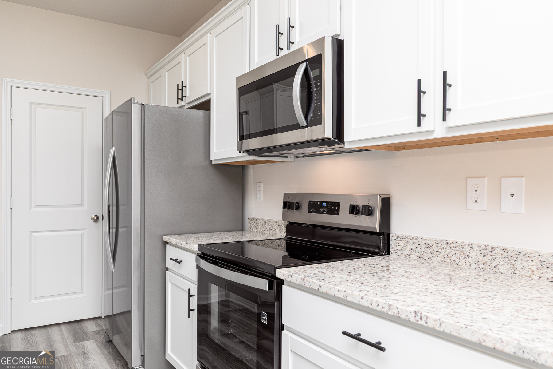495 Prescott Way Villa Rica, GA 30180 - Photo 6 of 13 a kitchen with stainless steel appliances granite countertop a refrigerator stove and microwave