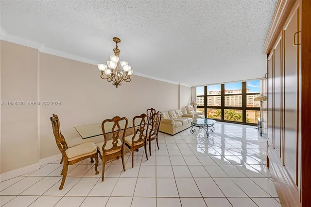 a dining room with chandelier and outdoor view