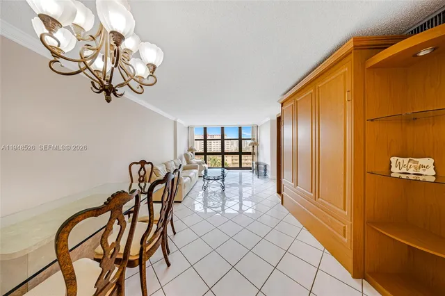 a view of a dining room with furniture and chandelier