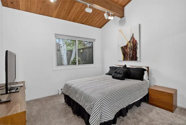 a view of a patio with table and chairs and potted plants with wooden floor and fence
