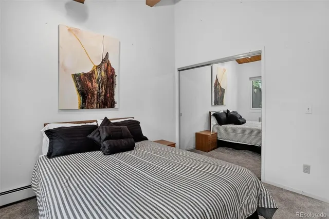 a view of a house with a bed and wooden floor