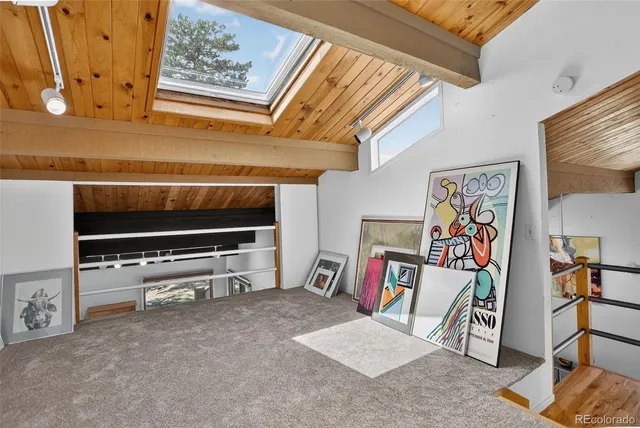 an aerial view of a house with yard and mountain view in back