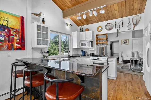 a kitchen with a stove a sink and a refrigerator