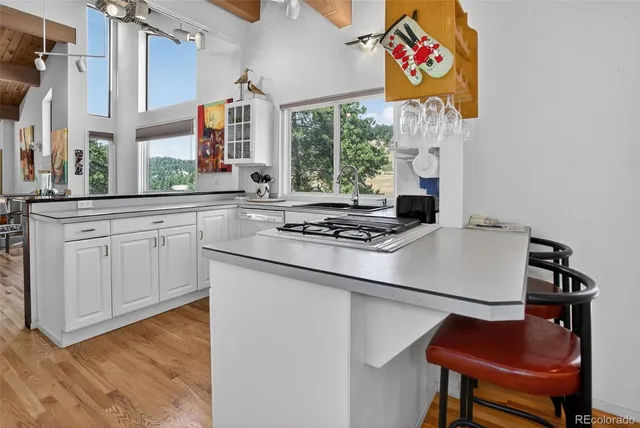 a view of a hallway with wooden floor and stairs