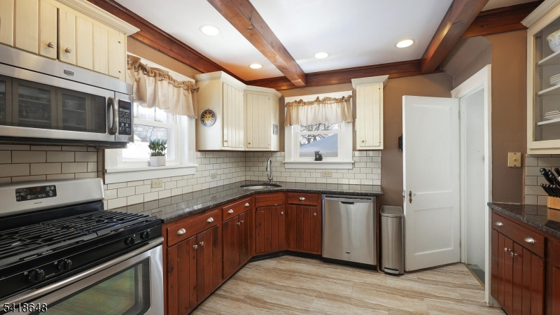 25 Paterson Road Fanwood, NJ 07023 - Photo 11 of 32 a kitchen with stainless steel appliances granite countertop a stove and a refrigerator