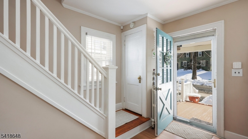 25 Paterson Road Fanwood, NJ 07023 - Photo 4 of 32 a view of a hallway with wooden floor and staircase