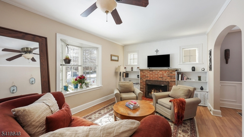 25 Paterson Road Fanwood, NJ 07023 - Photo 5 of 32 a living room with fireplace furniture and a flat screen tv