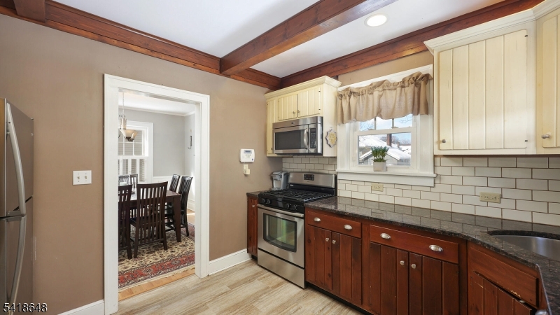 25 Paterson Road Fanwood, NJ 07023 - Photo 10 of 32 a kitchen with stainless steel appliances granite countertop a stove a sink and a refrigerator