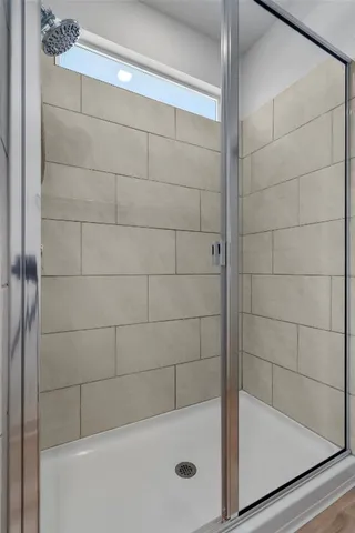 a bathroom with a granite countertop sink toilet a mirror and shower