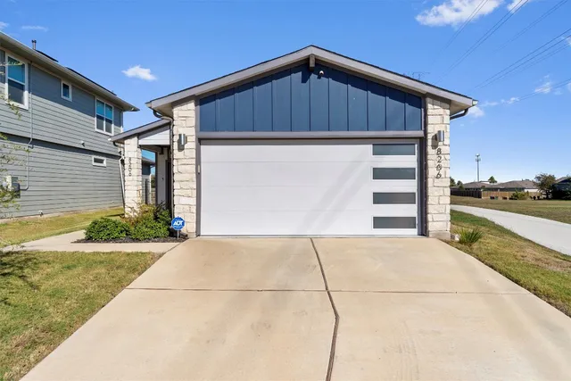 a view of kitchen with granite countertop stainless steel appliances refrigerator sink and microwave