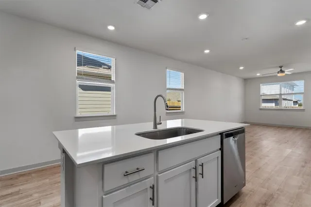 a kitchen with a sink and stainless steel appliances
