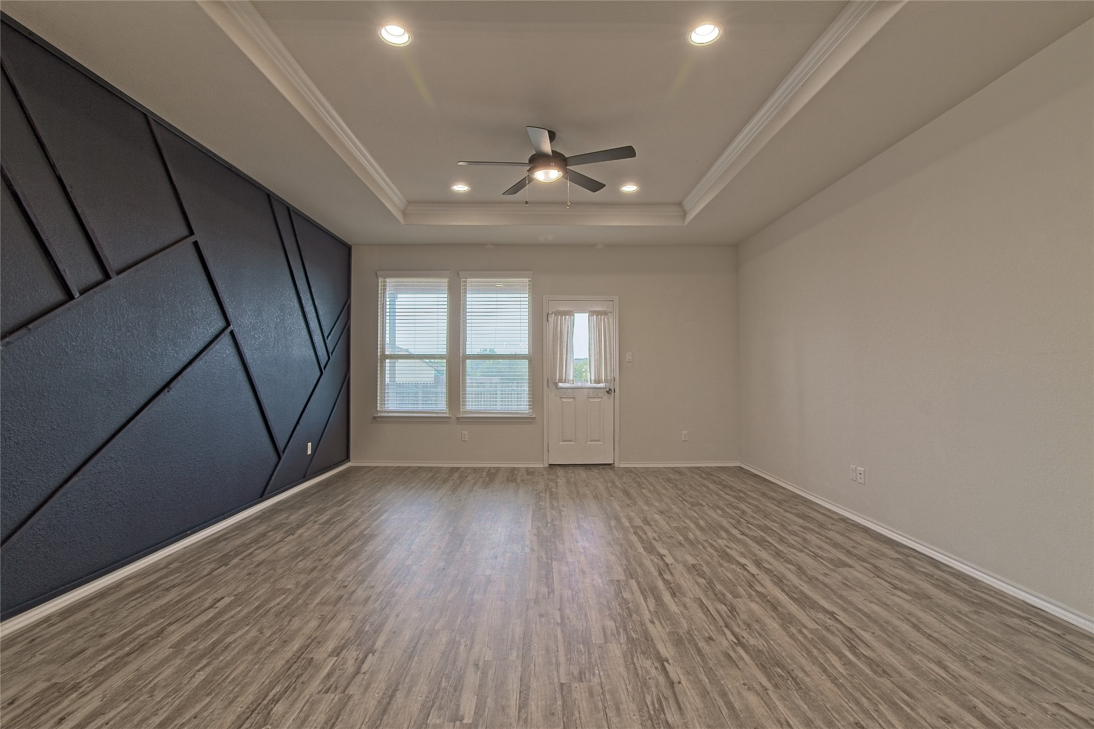 601 Hummingbird Lane Leander, TX 78641 - Photo 11 of 35 Spare room with a ceiling fan, wood finished floors, recessed lighting, a raised ceiling, and crown molding