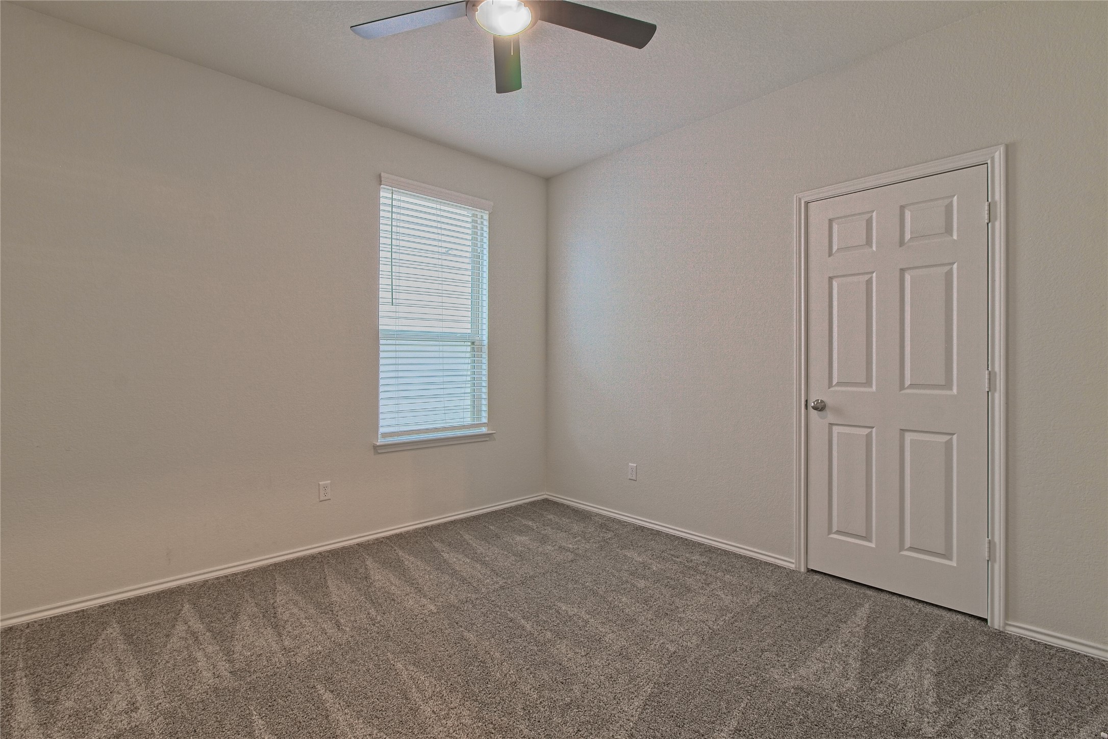 601 Hummingbird Lane Leander, TX 78641 - Photo 20 of 35 Empty room with dark colored carpet and ceiling fan