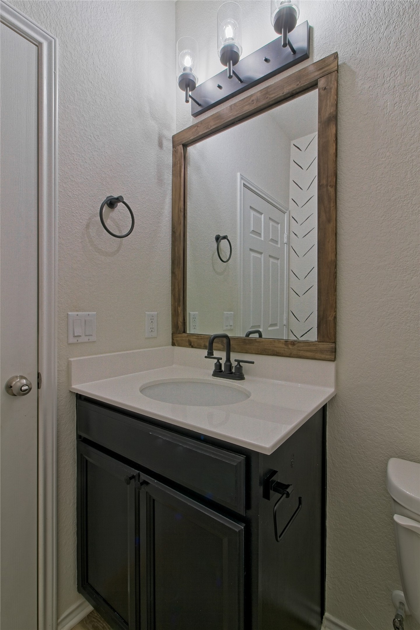 601 Hummingbird Lane Leander, TX 78641 - Photo 22 of 35 Half bathroom with a textured wall and vanity