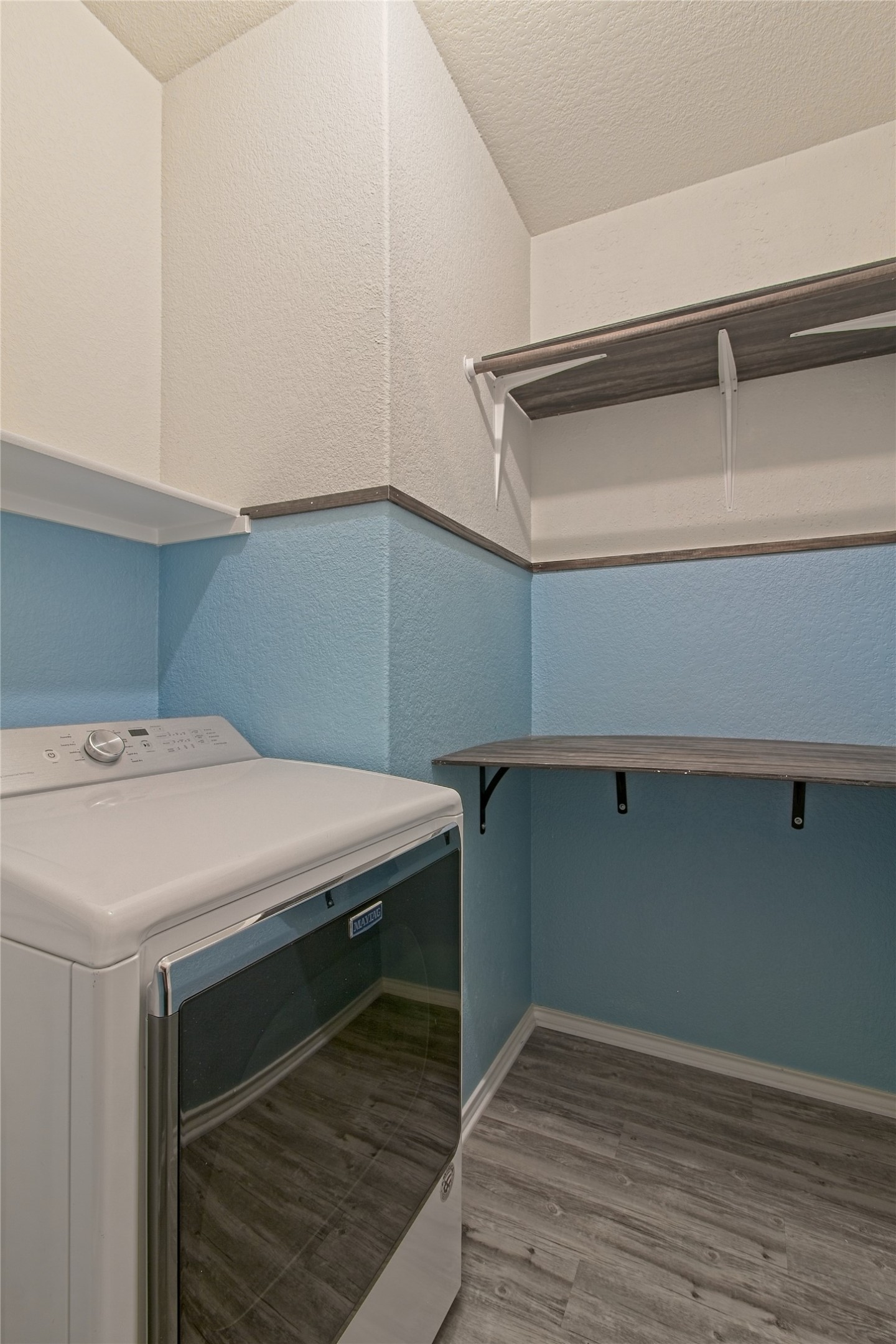601 Hummingbird Lane Leander, TX 78641 - Photo 23 of 35 Laundry area with light wood-type flooring, a textured ceiling, and a textured wall