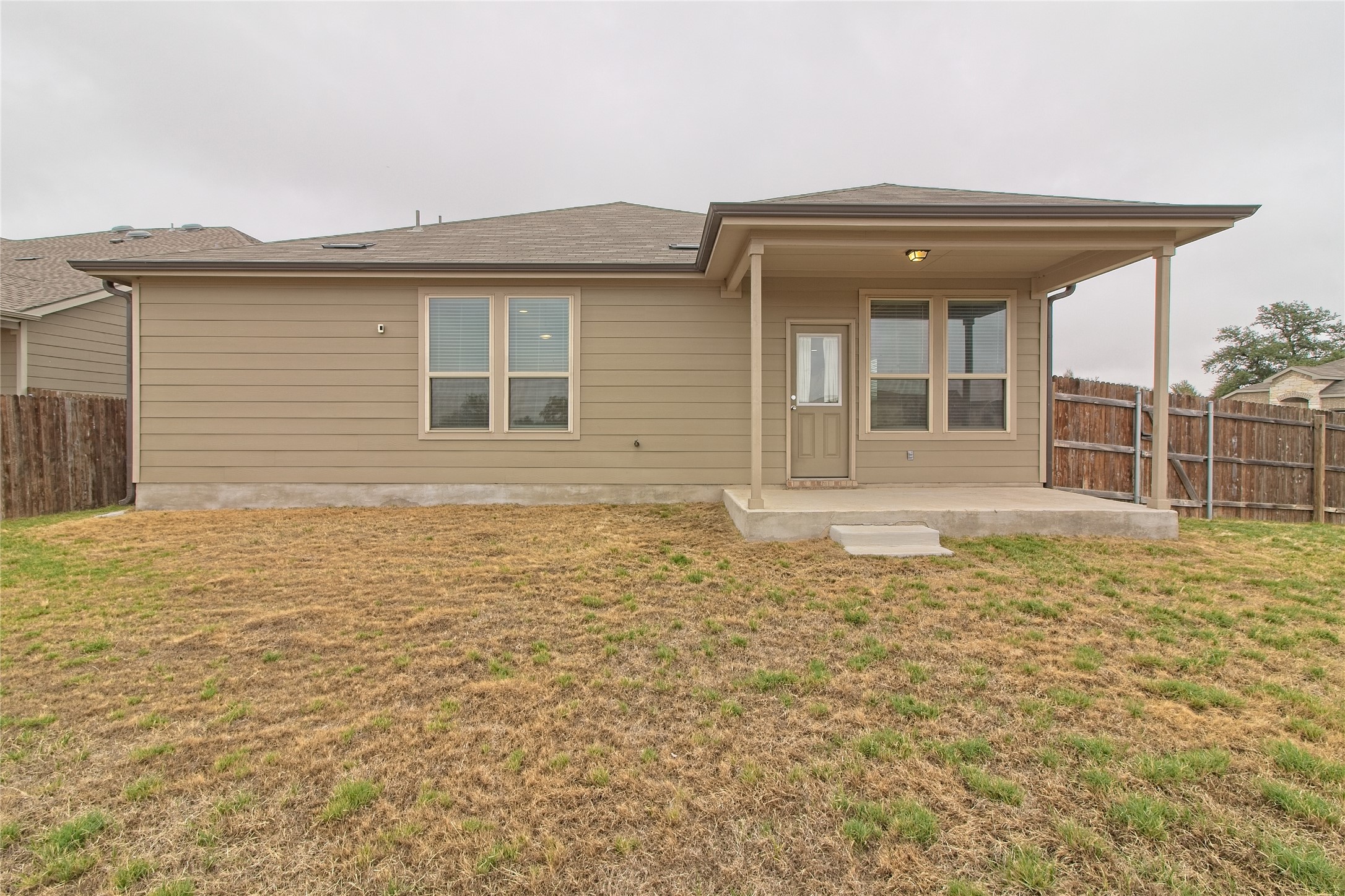 601 Hummingbird Lane Leander, TX 78641 - Photo 24 of 35 Rear view of house featuring a fenced backyard and a patio area